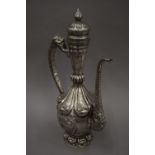 A Tibetan silver on copper repousse decorated ewer. 49 cm high.