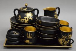 An early 20th century Japanese lacquered tea set. The tray 30 cm wide.