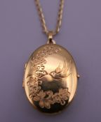 A 9 ct gold locket on chain. Locket 3 cm high, chain 50 cm long. 6.4 grammes total weight.