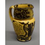 A Royal Doulton jug decorated with cats. 16 cm high.