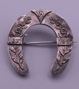 A Victorian silver Jubilee 1837-87 horseshoe brooch. 3 cm wide.