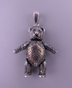 A 925 silver bear form pendant. 3 cm high excluding suspension loop.