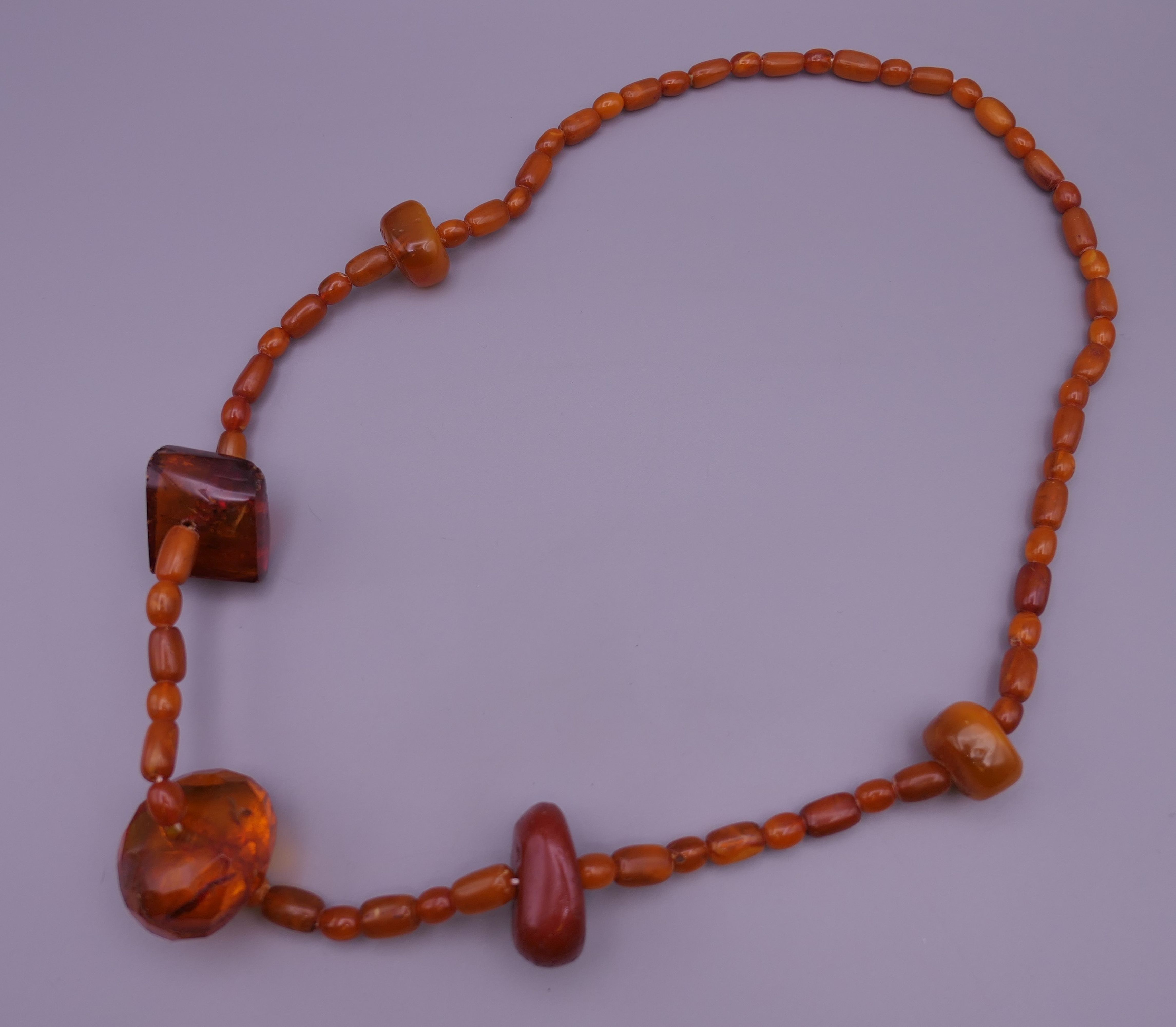 An amber necklace. 74 cm long.