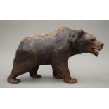 A Blackforest carved wooden bear. 43 cm long.