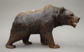 A Blackforest carved wooden bear. 43 cm long.