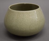 An Oriental celadon vase. 10.5 cm high.