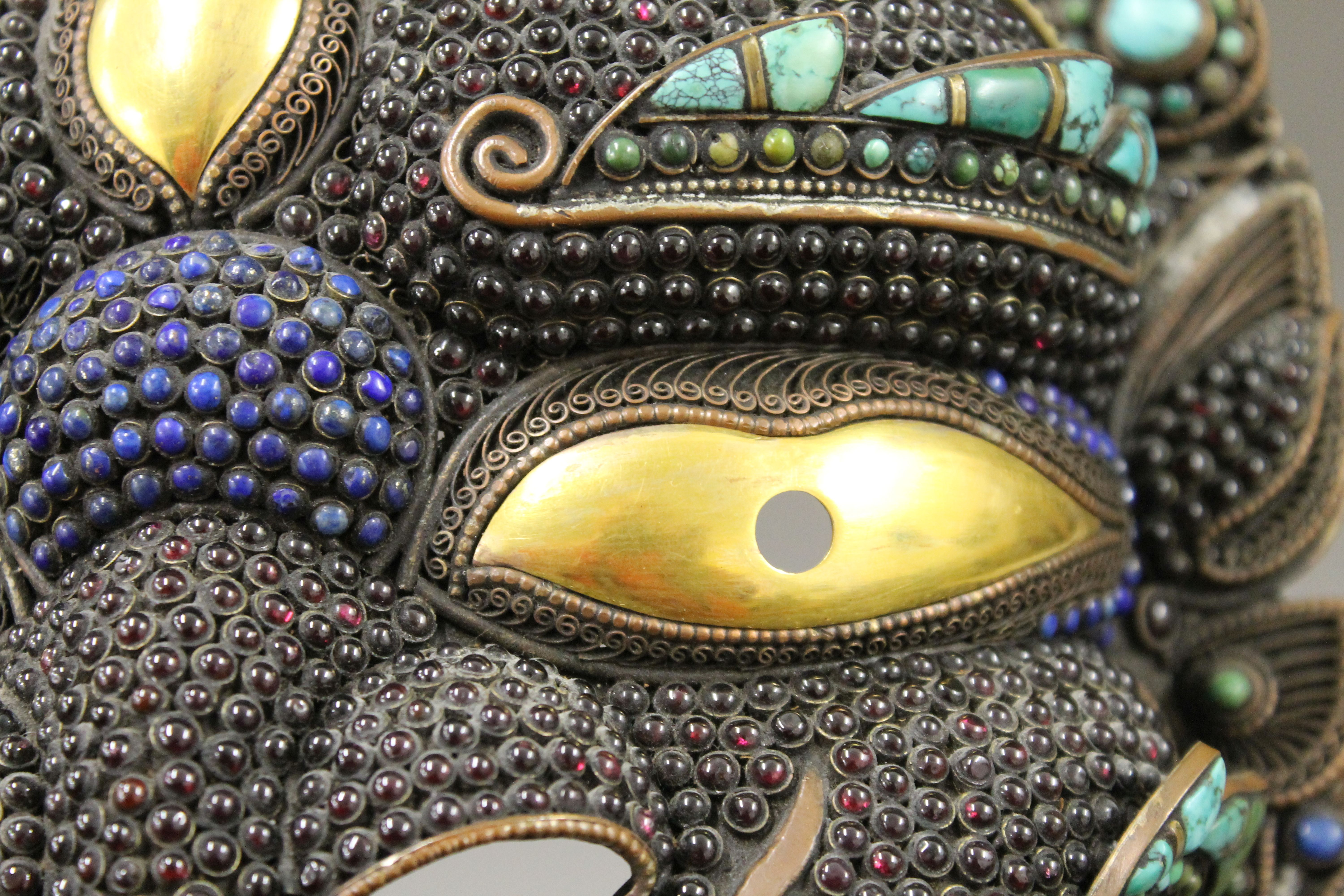 A Tibetan cabochon set copper and brass mask. 23 cm wide. - Image 4 of 5