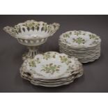 A Victorian florally decorated porcelain dessert service. The tazza 19 cm high.