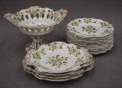 A Victorian florally decorated porcelain dessert service. The tazza 19 cm high.
