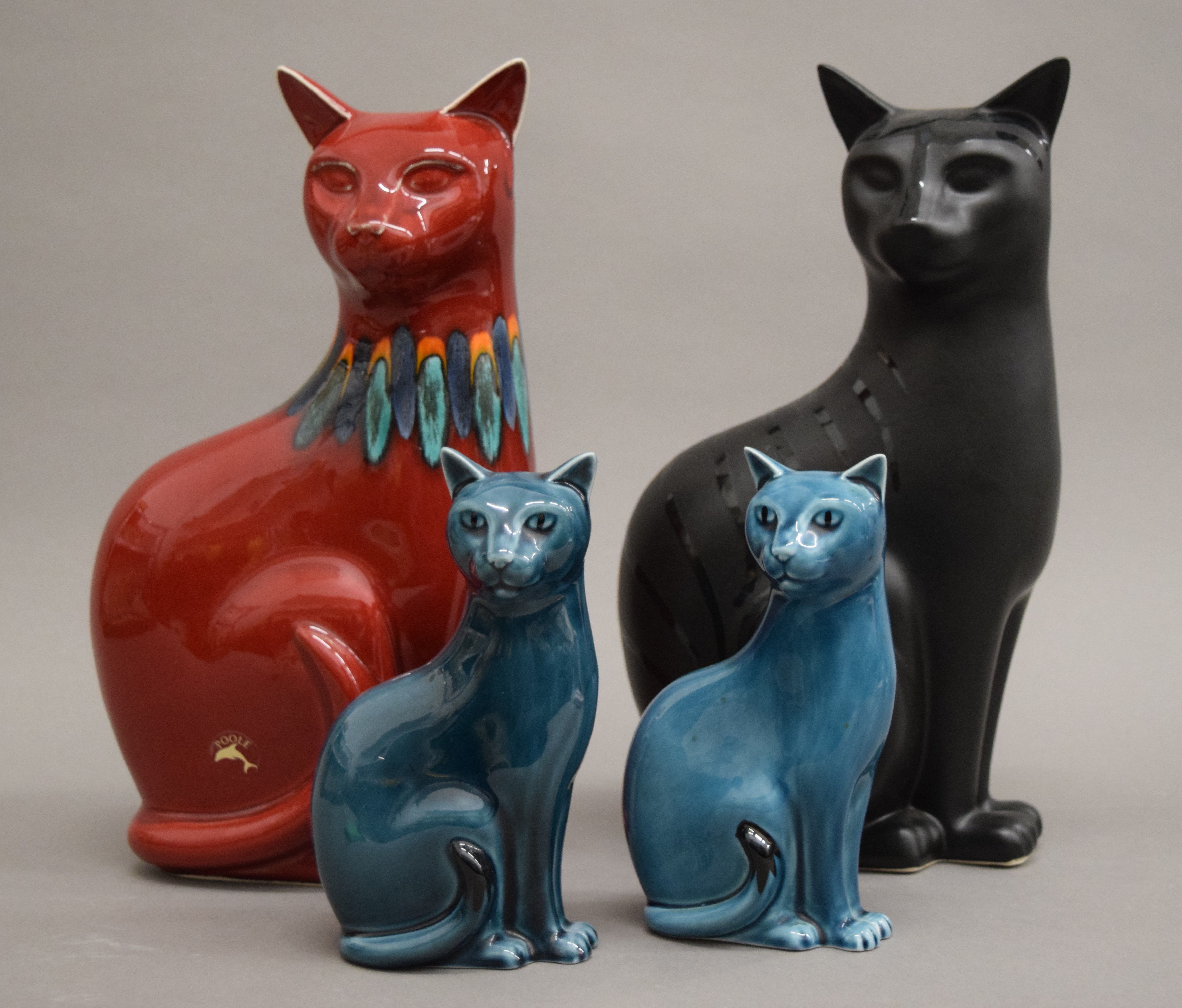 Four Poole pottery cats. The largest 29 cm high.