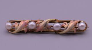 A Belle Epoque period 14 K gold pearl and three coloured enamel brooch. 4.5 cm long.