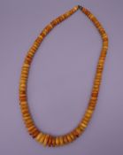 An amber necklace. 60 cm long.