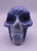 A carved model of a skull. 5.5 cm high.