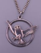 A silver pendant on chain formed as an owl. The pendant 4 cm wide. 30.9 grammes.