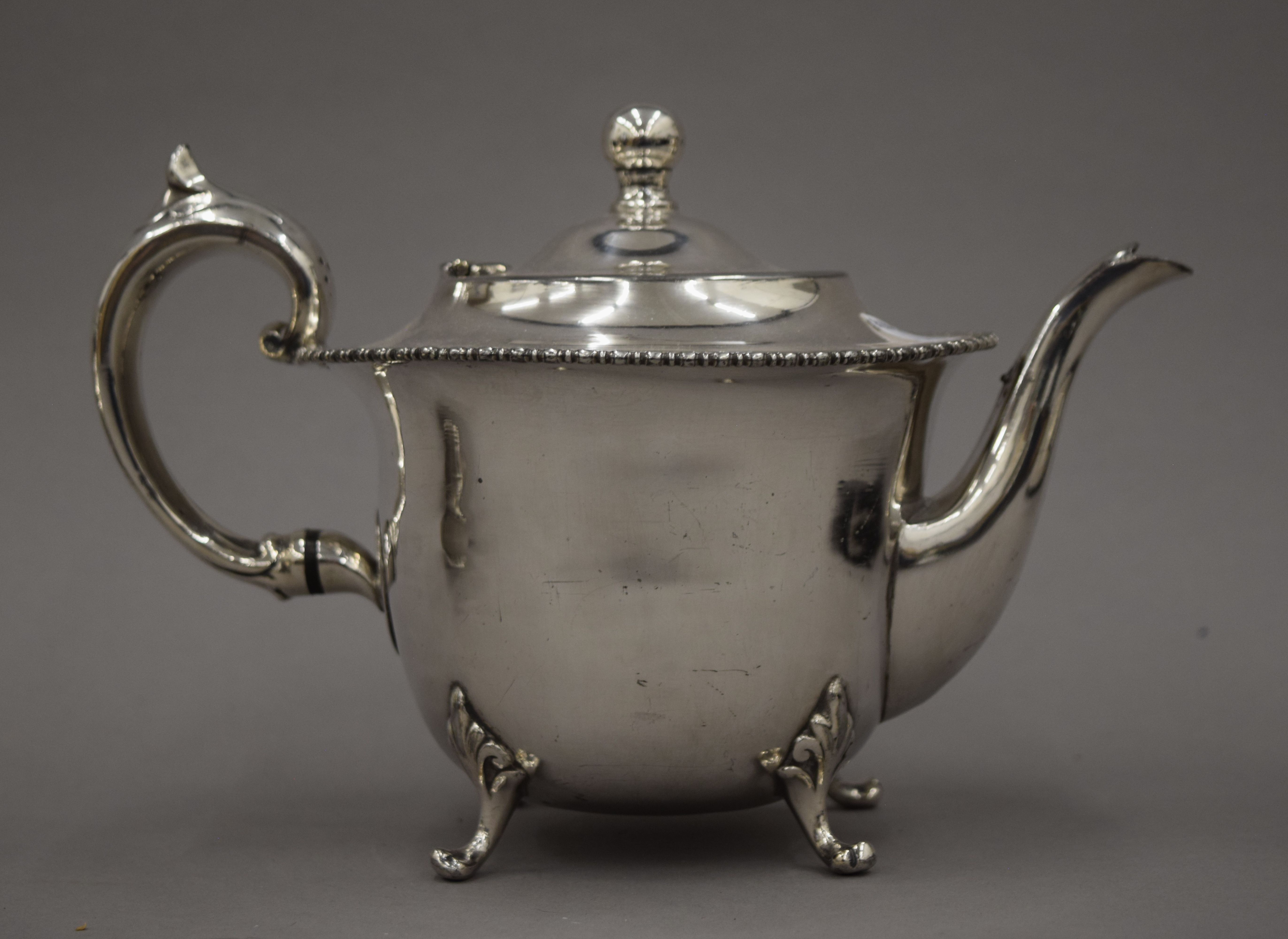 A three-piece silver plated tea set and a three-piece porcelain and silver overlaid tea set and an - Image 7 of 10