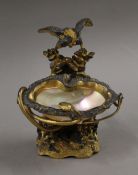 A gilt bronze and mother-of-pearl salt surmounted with an eagle and a snake. 15 cm high.