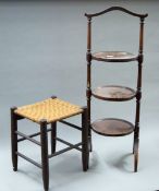 An Edwardian mahogany three-tier cake stand and a rattan topped stool. The former 91 cm high.