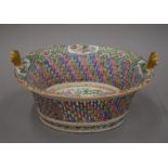 A 19th century Canton famille rose porcelain basket. 28.5 cm wide.
