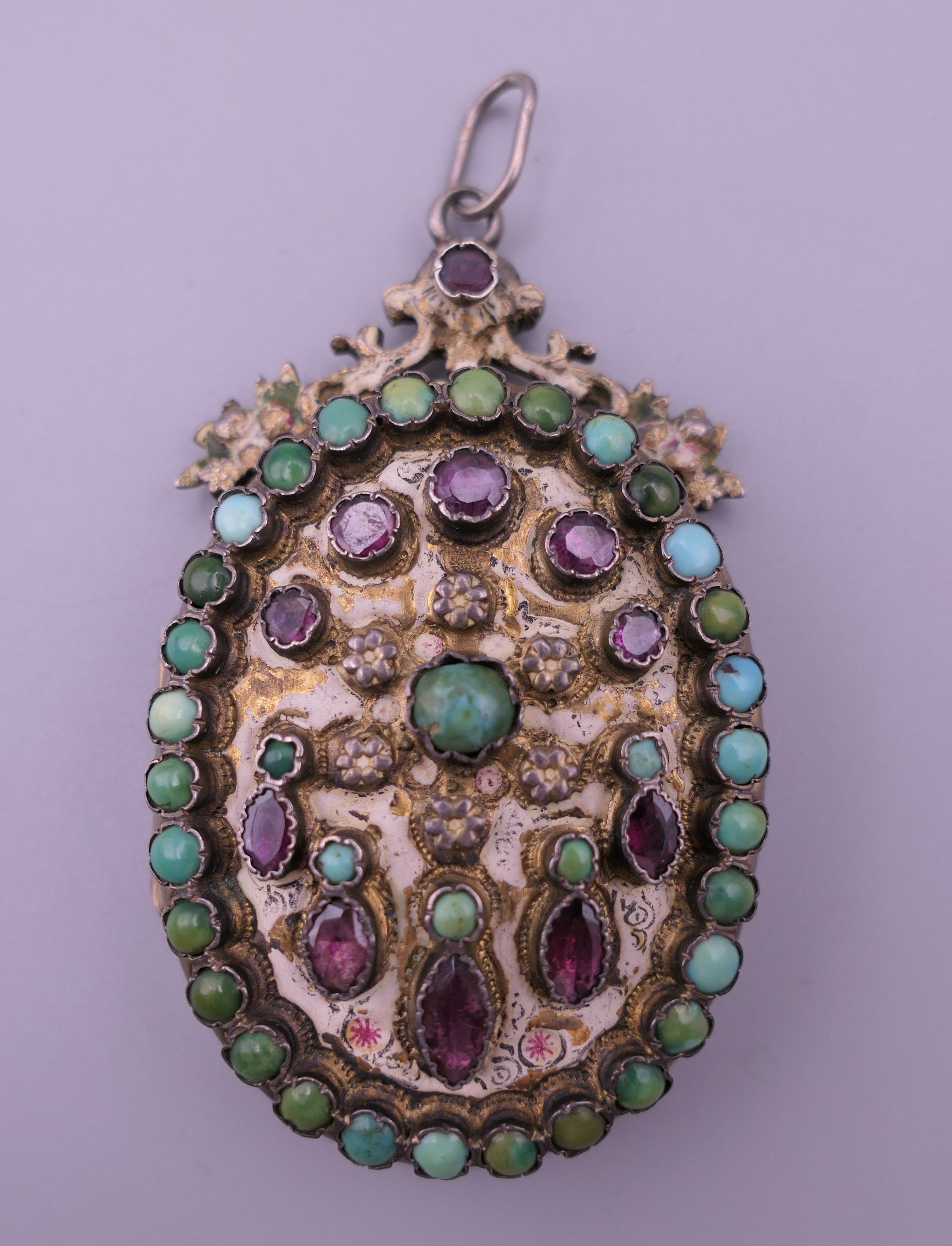 A silver Austro Hungarian turquoise and garnet pendant locket. 6 cm high.