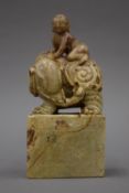 A finely carved Chinese soapstone seal carved with a boy and an elephant. 19 cm high.