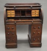 A Victorian mahogany roll top desk. 89.5 cm wide.