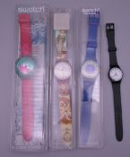 Four Swatch wristwatches, three boxed.