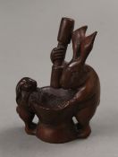 A carved pair of rabbits with a pestle and mortar. 10.5 cm high.