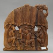An African wooden carving depicting tribal figures in a hut. 40.5 cm high.