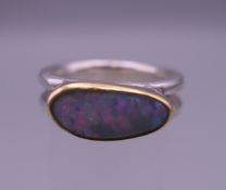 A Contemporary opal set silver ring. Ring size O/P.