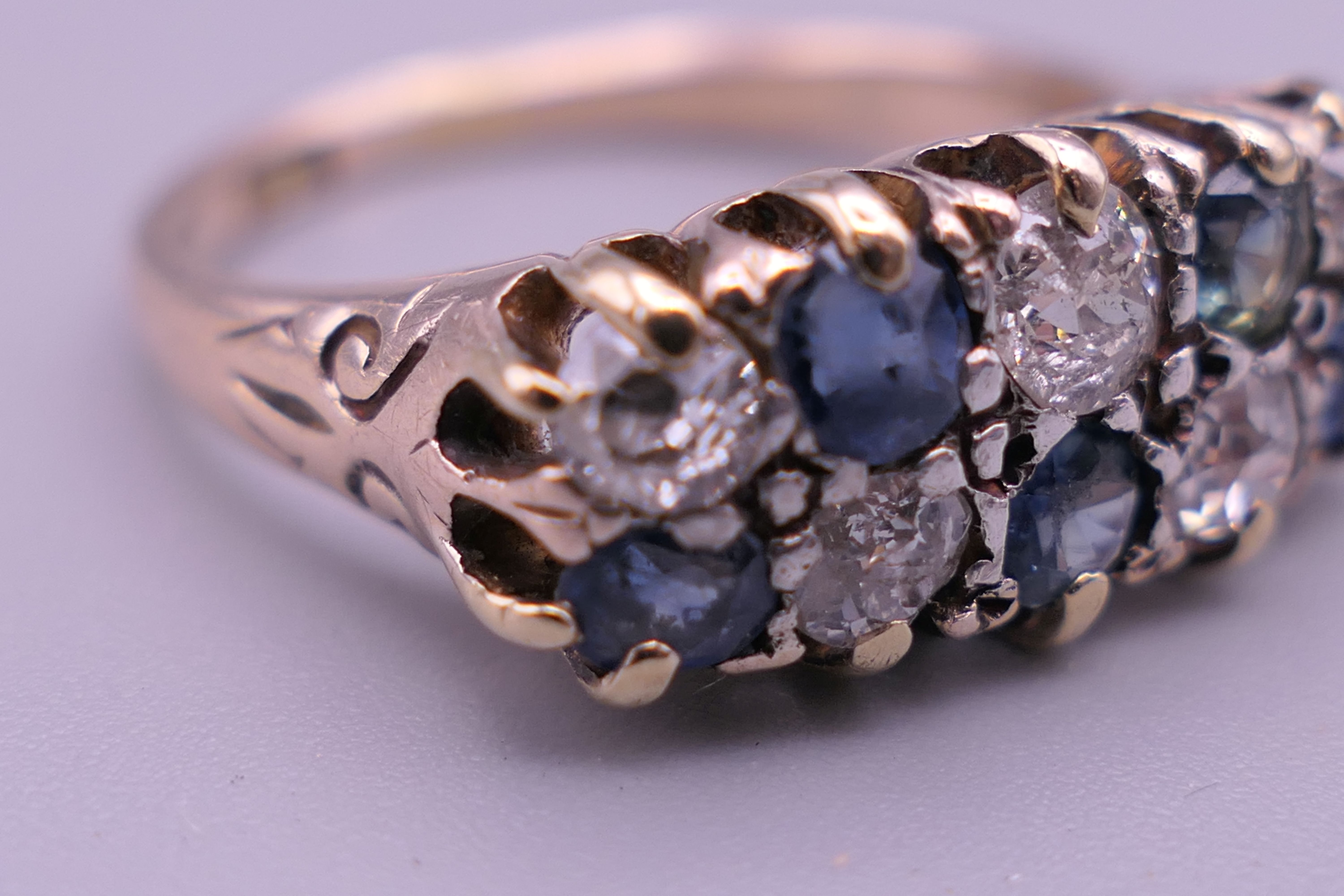 An 18 ct gold diamond and sapphire ring. 8 mm high, 17 mm wide. Ring size Q/R. - Image 4 of 8