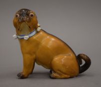 A 19th century Continental porcelain model of a pug dog. 10 cm high.