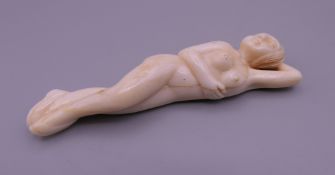 A carved bone model of a doctor's figure. 9 cm long.