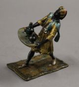 A cold painted bronze model of an Arab carrying a tray. 10.5 cm high.