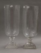 A pair of cut glass storm lamps. 40 cm high.