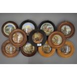 Eleven 19th century Pratt Ware pot lids, each mounted in a wooden frame.