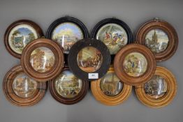 Eleven 19th century Pratt Ware pot lids, each mounted in a wooden frame.