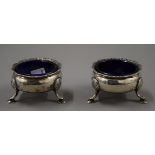 Two silver salts with blue glass liners. 7 cm diameter. 171.8 grammes.