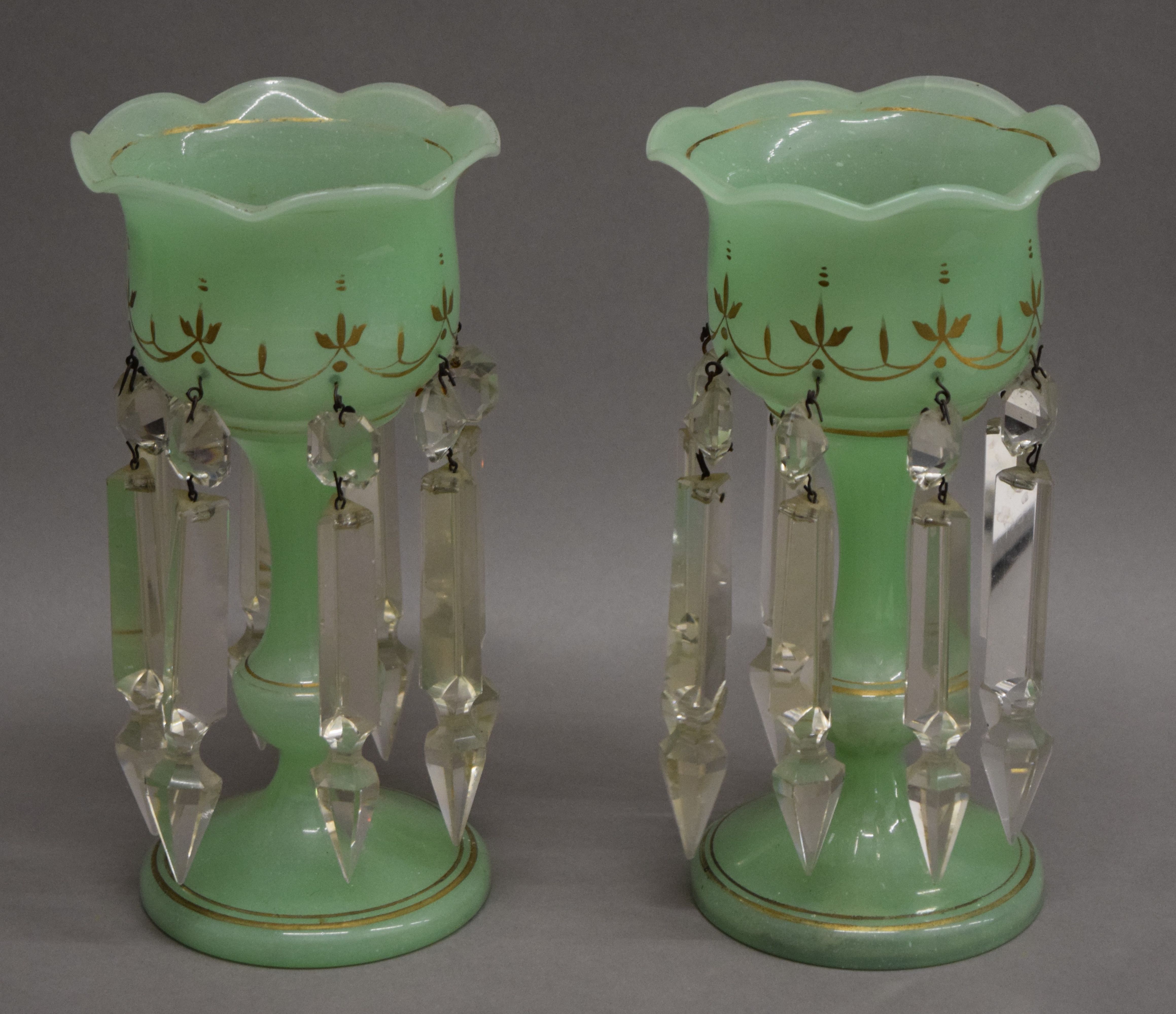 A small pair of Victorian green glass lustres. 22.5 cm high.