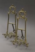 A pair of brass table easels. 41 cm high.