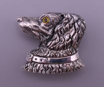 A silver dog form brooch. 3 cm high.