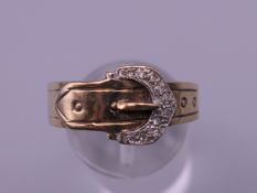 A 9 ct gold diamond chip set buckle ring. Ring size U/V. 4.2 grammes total weight.