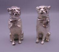 A pair of silver plated dog form peppers. 6 cm high.