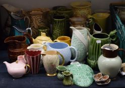 A large quantity of ceramic jugs, vases, etc., including Wade, Sylvac, Wedgwood, etc.