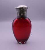 A Victorian silver topped cranberry glass scent flask. 9 cm high.