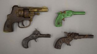 Four 19th/20th century toy cap pistols.