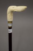 A walking stick with a carved bone handle formed as a dog. 96 cm long.