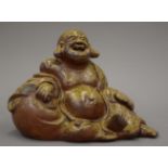 A salt glaze model of Buddha, stamped to the interior. 21 cm wide.
