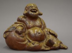 A salt glaze model of Buddha, stamped to the interior. 21 cm wide.