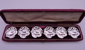 A cased set of six Art Nouveau silver buttons, each decorated with a swan. Each 2.5 cm wide.
