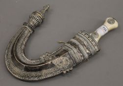 A 19th century bone handled Jambiya in an associated unmarked white metal scabbard.